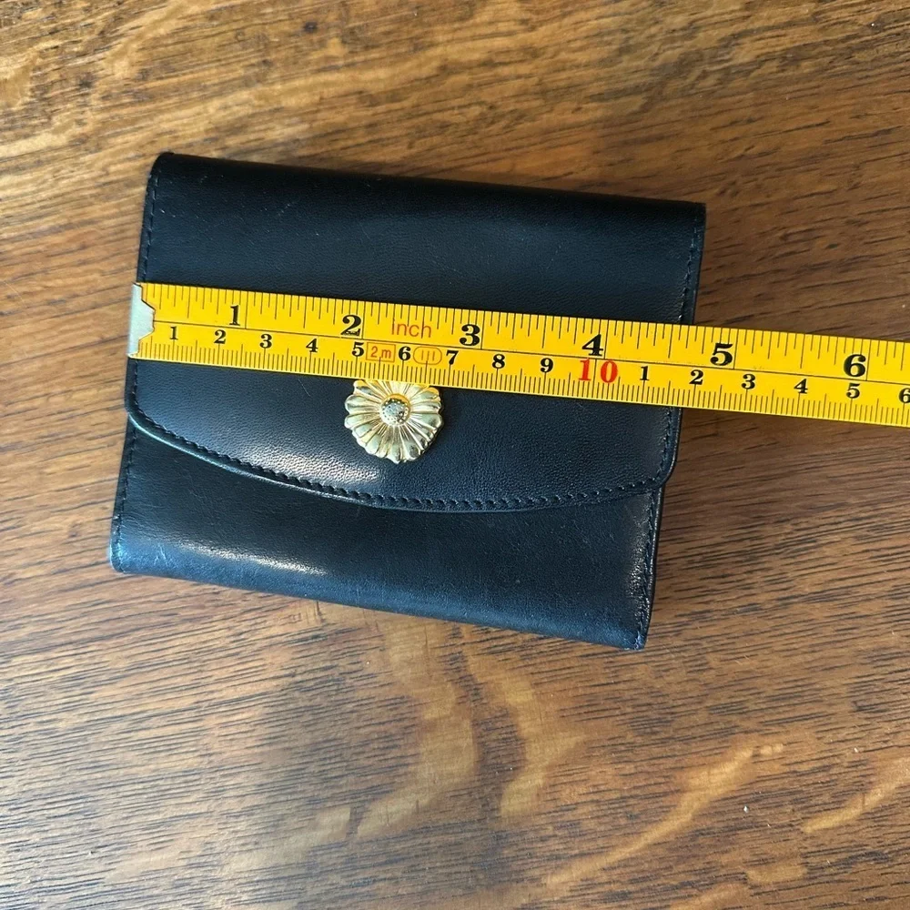 Black leather wallet with a red interior.